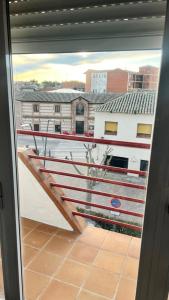 a balcony with a view of a building from a window at Apartamento La Celestina in La Puebla de Montalbán