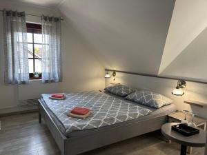 a bedroom with a bed with two towels on it at Penzion Villa Alena in Velké Bílovice