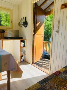 an open door to a kitchen with a porch at Camping Le Vert-Bois - Corrèze in Saint-Martin-la-Méanne +25 photos