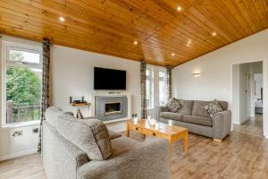 a living room with two couches and a tv at Field View 2 bed - Hazel in Eye