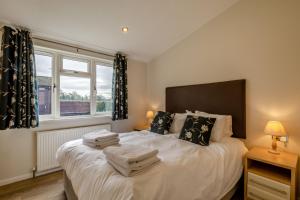 a bedroom with a bed with white sheets and pillows at Field View 2 bed - Hazel in Eye