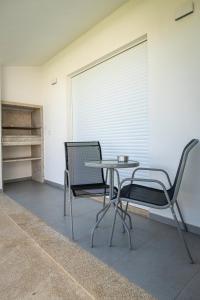 two chairs and a table in a room at Casa do Santo Estevão in Macedo de Cavaleiros