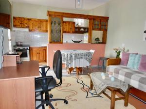 a kitchen and living room with a table and a couch at Quiet Mountain View Retreat Helicon, Kyriaki in Kiriákion
