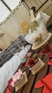a table with a bottle of wine and glasses and strawberries at Casa Bella Teepees in Zújar +98 photos