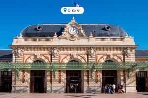 a building with a clock on the top of it at Ikonik Marengo in Nice