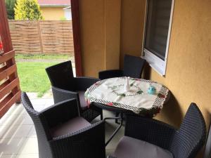a table with a cake on it with chairs at Lena Lodge in Fonyód