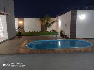a large blue pool in the middle of a patio at Casa Oliveira in Montes Claros