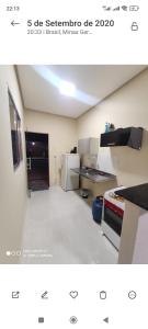 a picture of a room with a kitchen with a counter at Casa Oliveira in Montes Claros