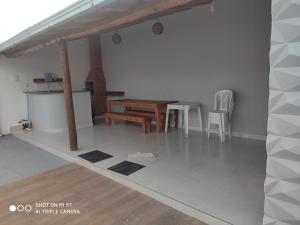 a dining room with a table and chairs in a room at Casa Oliveira in Montes Claros