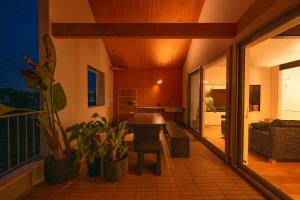a living room with a table and some plants at NAGASHIMA clas in Kuwana +100 photos