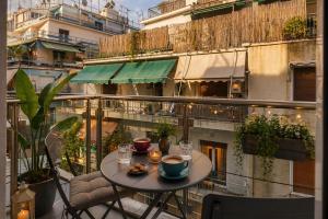 a table and chairs sitting on a balcony at The Q Hotel in Athens