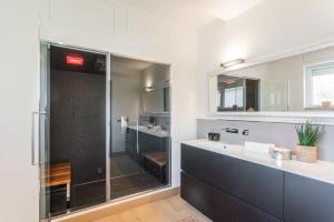 a bathroom with a glass shower and a sink at Villa Chiara in Stresa