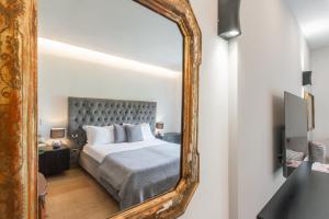 a bedroom with a bed and a large mirror at Villa Chiara in Stresa