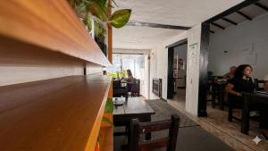 a bar with people sitting at tables in a restaurant at Hotel Premium Real in Medellín