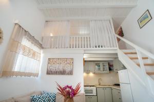 a living room with a staircase and a kitchen at Anna's Apartment Marmara Paros in Kampos Paros