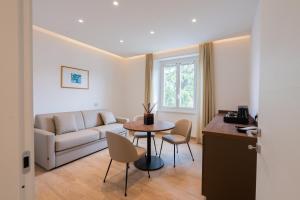 a living room with a table and a couch at Dante Suites in Pergola