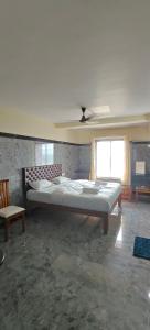 a bedroom with two beds and a ceiling at Seaside Residency Murudeshwara in Māvalli