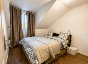 a bedroom with a bed and a window at Appartement St denis in Saint-Denis