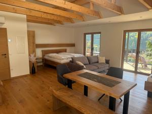 a living room with a bed and a table at Weinloft Gamlitz in Gamlitz