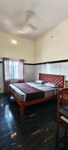 a bedroom with a large bed in a room at Seaside Residency Murudeshwara in Māvalli