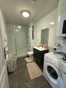 a bathroom with a washing machine and a washer at Appartement St denis in Saint-Denis +27 photos