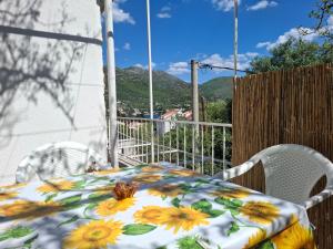 a table and chairs on a balcony with a view of mountains at Peaceful retreat beach in Zaton