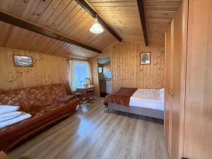 a bedroom with a couch and a bed in a room at OW Gabi in Międzywodzie