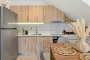 a kitchen with wooden cabinets and a table with chairs at Cassiopeia in Akrotiri +28 photos