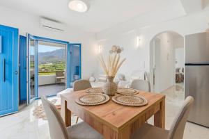 a dining room with a wooden table and chairs at Cassiopeia in Akrotiri
