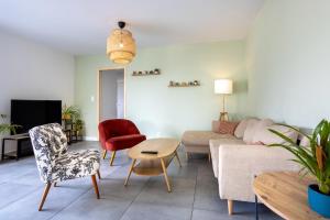 a living room with a couch and a table at Maison neuve pmr proche plage in Concarneau
