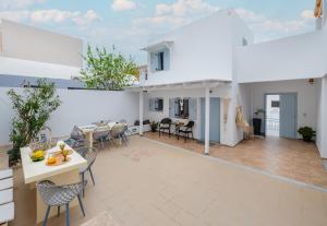 a large living room with a table and chairs at Begi Luxury Villas in Karterados +76 photos