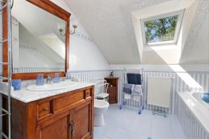 a bathroom with a sink and a toilet and a window at Chez Anne-Marie et Constant in Pornichet +19 photos