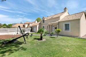 a house with a playground in the yard at Chez Anne-Marie et Constant in Pornichet