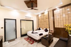 a living room with a bed and a couch at Rath Inns Beach Resort Mandarmani in Mandarmoni +23 photos