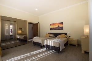 A bed or beds in a room at Le Cupoline
