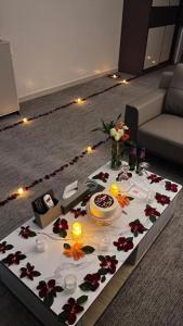 a table in a living room with a cake and flowers at Qimam Park Hotel Al-baha 7 in Al Baha
