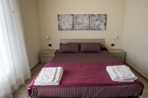 A bed or beds in a room at Le Cupoline