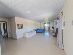 a large room with a bed and a couch at Casa completa, Praia e Rio in Extremóz