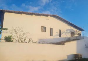 a white building with windows on the side of it at Casa completa, Praia e Rio in Extremóz
