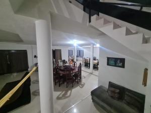 a dining room and living room with a table and chairs at Casa completa, Praia e Rio in Extremóz