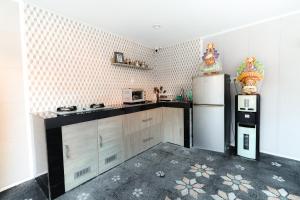 a kitchen with a refrigerator and a microwave at Komala Indah 2 in Badung +12 photos