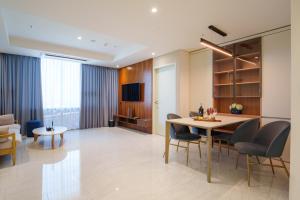 a dining room and living room with a table and chairs at The First Clark Hotel and Residence in Pampang