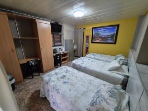 a hotel room with two beds and a desk at N4 Guest Lodge in Rustenburg +45 photos