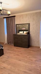 a room with a dresser with a mirror on the wall at Vardzia Guesthouse Tmogvi in T'mogvi