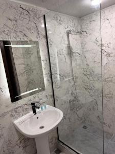 a bathroom with a sink and a shower at Vardzia Guesthouse Tmogvi in T'mogvi