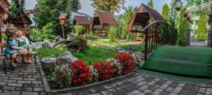 a little girl sitting in a chair in a garden at Zakarpattya in Polyana