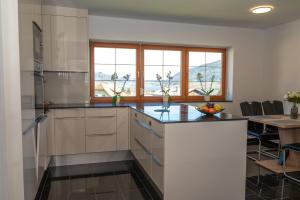 a kitchen with a large island with a counter top at Ferienwohnungen Tarmann in Bodensdorf