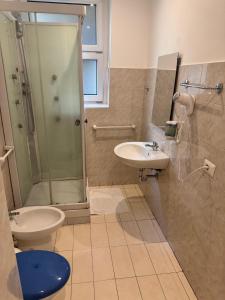 a bathroom with a shower and a toilet and a sink at Hotel Vintage Milano Centrale in Milan