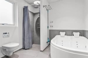a bathroom with a white tub and a toilet at 30441-Odder-Strandvaenget-12 in Odder +42 photos