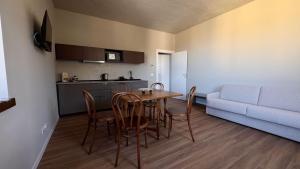 a living room with a table and chairs and a couch at Ca' Giulia in Rigoso